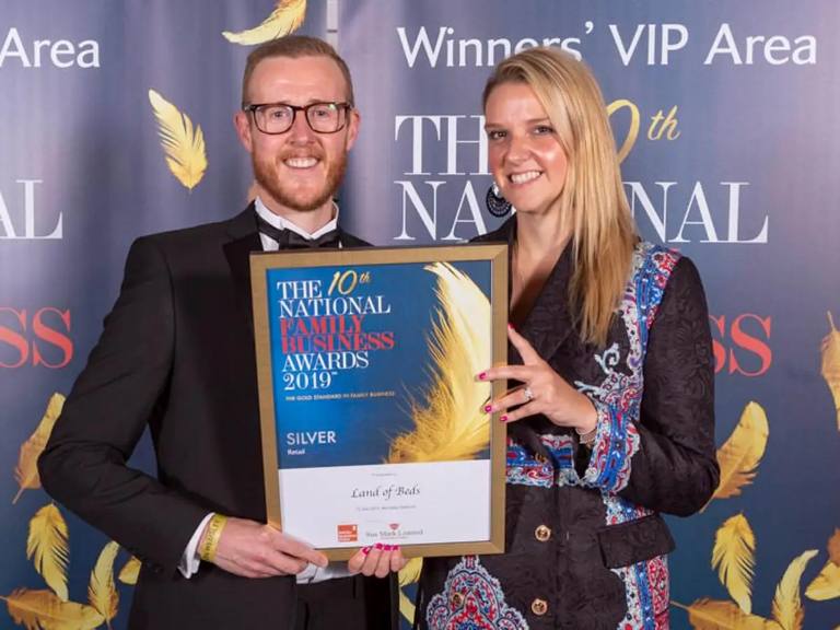 Mike Murray holding the Silver Retail award Land of Beds won at The National Family Business Awards 2019.