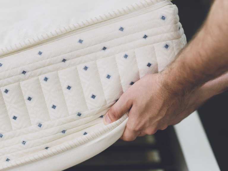 Man removing old mattress