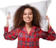 Woman in tartan pyjamas with pillow